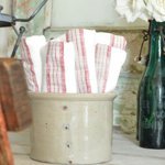 Stoneware utensil crock with dish towels