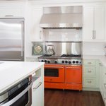 Orange oven with mint cabinets