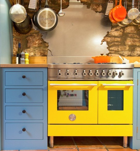 Yellow Bertazzoni range in a Shaker kitchen