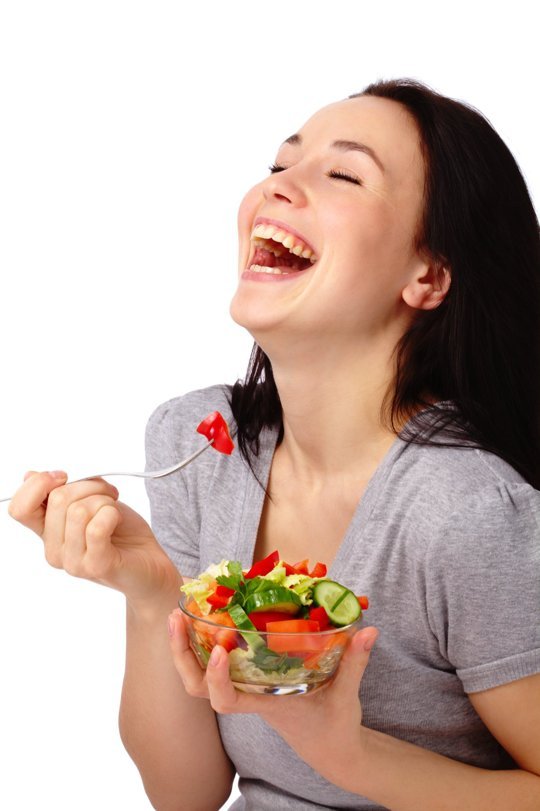 woman laughing with salad