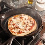 Finished pizza in skillet on stovetop