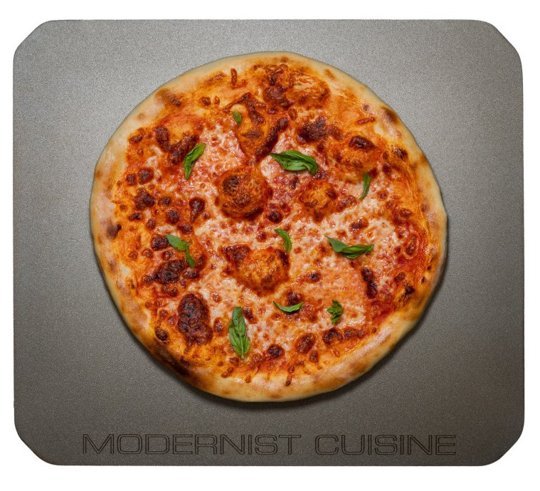 Modernist Cuisine Baking Steel with pizza on top