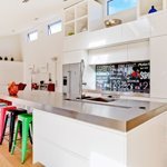 Candy colored bar stools in a white kitchen