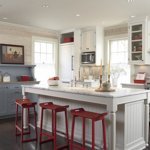 neutral kitchen with red barstools and red accents