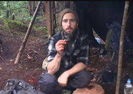 Survivalist man eating seaweed