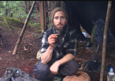 Survivalist man eating seaweed